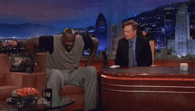 two men are dancing on a stage in front of a full moon