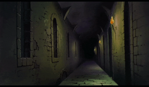 a dark hallway with a light on the wall