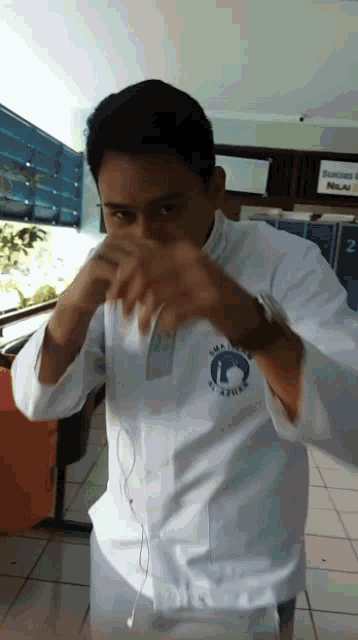 a man wearing a white shirt that says ' sma ' on the front of it