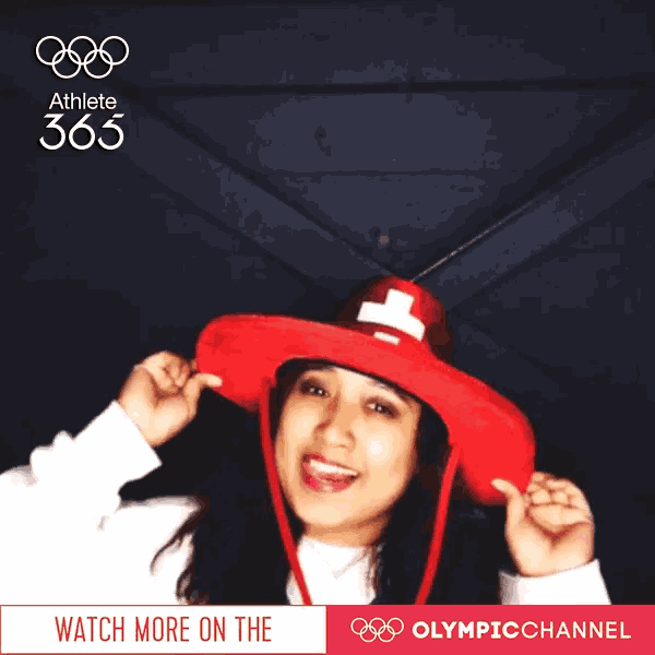 a woman wearing a red hat with a white cross on it