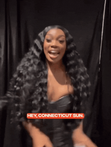 a woman with long black hair is smiling with the words hey connecticut sun above her