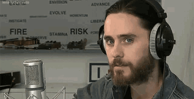 a man with a beard wearing headphones and a microphone