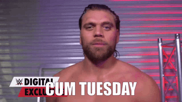 a man with a beard is standing in front of a sign that says " digital exclude cum tuesday "