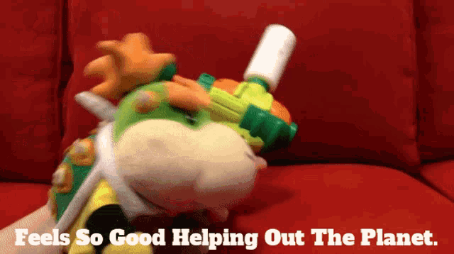 a stuffed animal on a red couch with the words " feels so good helping out the planet "