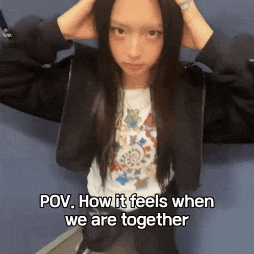 a girl with long black hair is wearing a black jacket and a white shirt that says ' pov ' on it