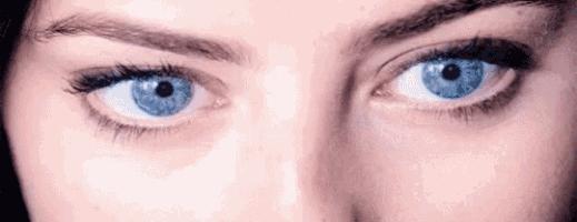 a close up of a woman 's eyes with blue eyes .