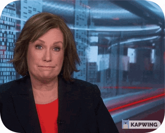 a woman is making a funny face in front of a screen that says kapwing on it