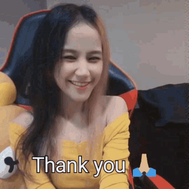 a woman in a yellow shirt is smiling with the words thank you below her