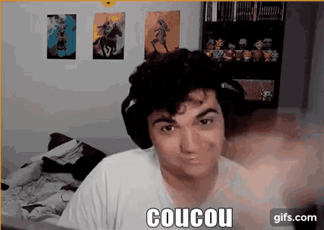 a man wearing headphones is making a funny face and says coucou