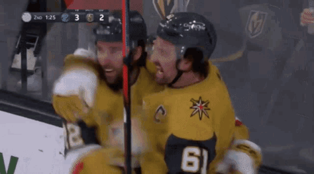 two hockey players are hugging each other and one has the number 61 on his jersey