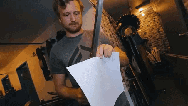 a man holding a piece of paper that says ' ii ' on it