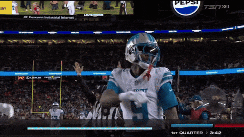 a football game is being played in front of a pepsi ad