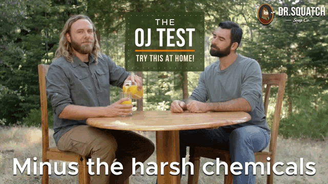 two men sitting at a table with a sign that says the oj test