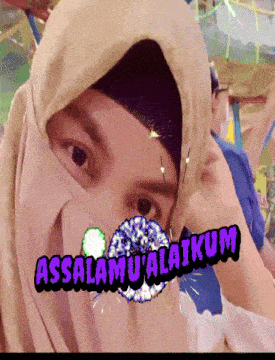a woman wearing a hijab with the words assalamu ' alaikum on her face