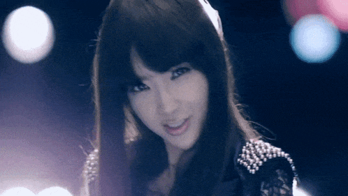 a woman with long hair is smiling and looking at the camera