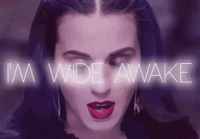 a close up of a woman 's face with the words `` i 'm wide awake '' coming out of her mouth .