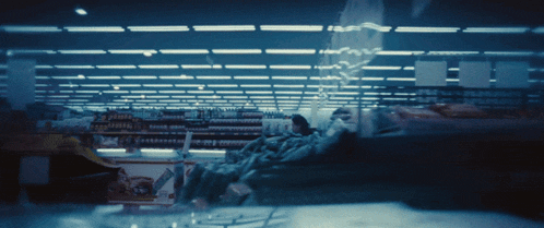 a blurred image of a store aisle with a sign that says ' jumbo ' on it
