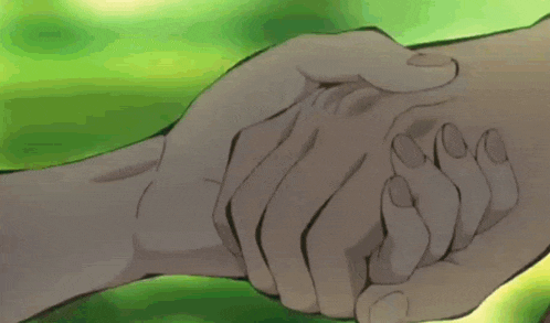 a close up of a person holding another person 's hand