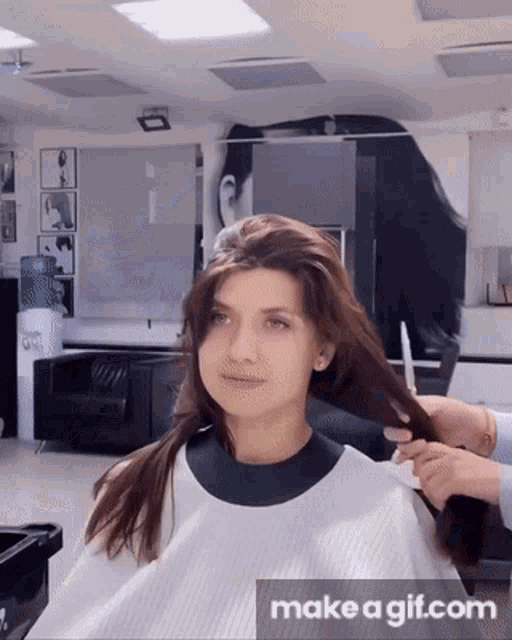 a woman is getting her hair cut by a man in a hair salon