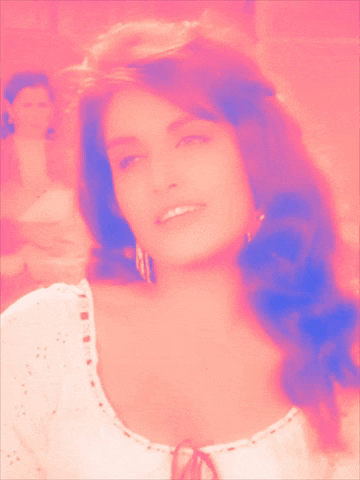 a close up of a woman 's face with pink and blue tones