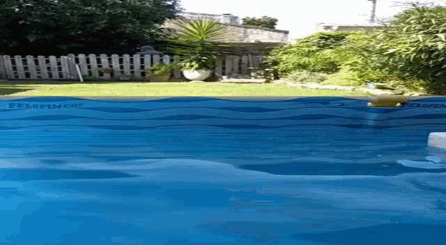 a large swimming pool with a fence in the background and a sign that says ' thermal ' on it