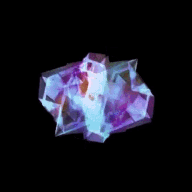 a rainbow colored crystal is floating in the air against a black background .