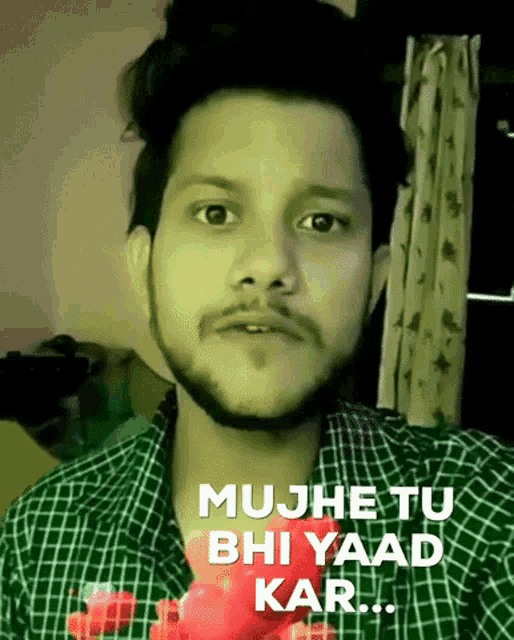 a man in a plaid shirt with the words mujhe tu bhi yaad kar