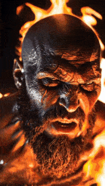 a close up of a man with a beard in front of fire