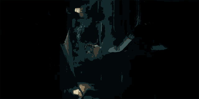 a person is laying on their back in a dark room