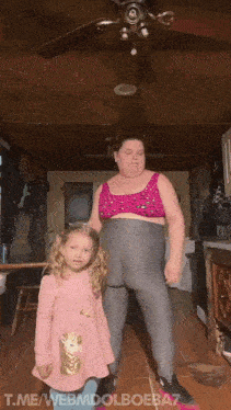 a little girl in a pink dress is standing next to a fat woman in a pink bra