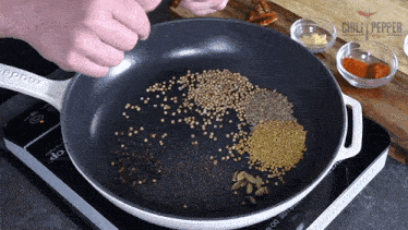 Adding Kashmiri Chilies Chili Pepper Madness GIF - Adding Kashmiri Chilies Chili Pepper Madness Preparing The Curry Powder GIFs