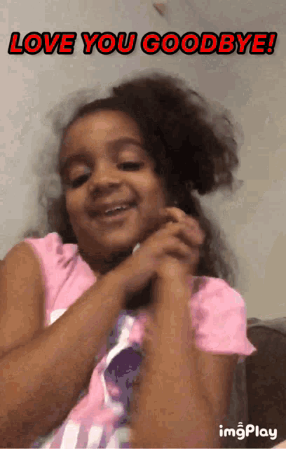 a little girl in a pink shirt with the words love you goodbye