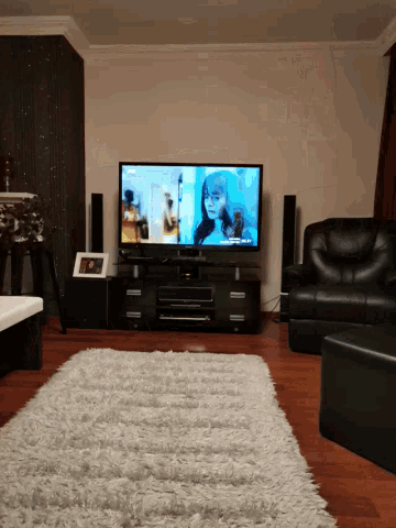 a living room with a flat screen tv which says netflix on it