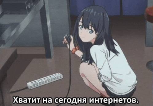a girl is kneeling down next to a power strip and holding a cord .