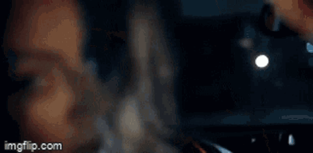 a close up of a person 's face with the website imgflip.com in the background