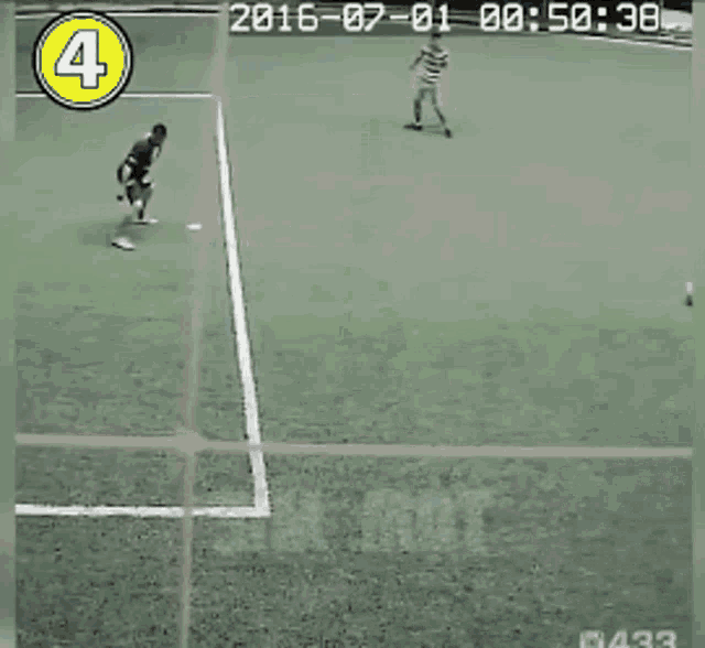 a group of people are playing soccer on a field with the number 4 on the corner