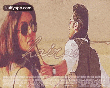 a man and a woman are standing next to each other . the woman is wearing sunglasses .