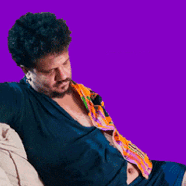 a man is sitting on a couch with a purple background and the word attenta on the bottom