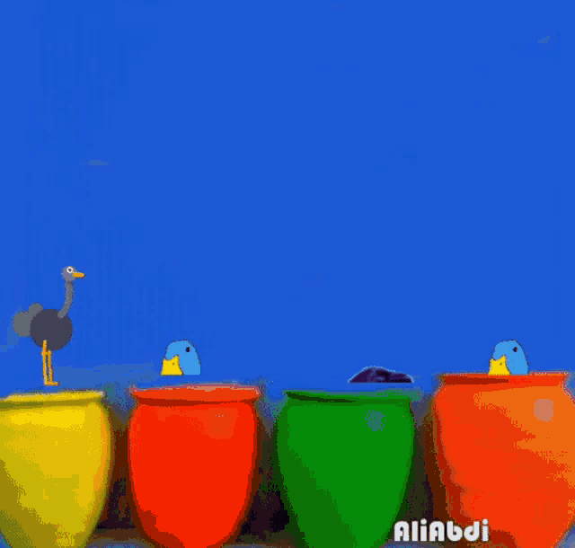 a row of colorful clay pots with a duck and a crow on them