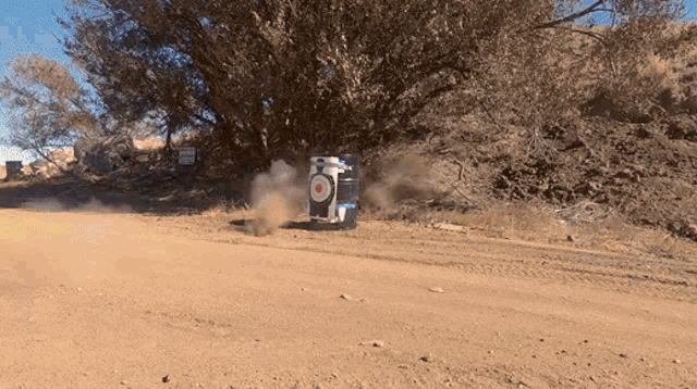a barrel with a target on it is on the side of the road