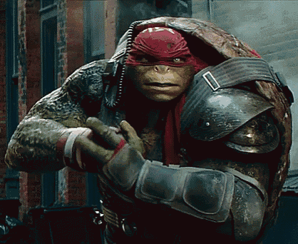 a teenage mutant ninja turtle with a red headband and armor