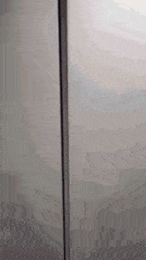 a close up of a gray wall with a few lines