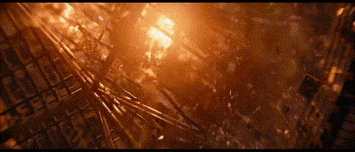 an aerial view of a burning building with a lot of smoke
