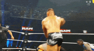 a man in a wrestling ring with the word raw on the side