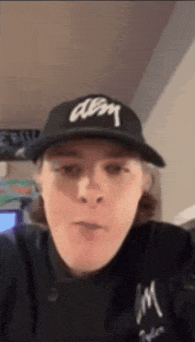 a person wearing a black hat that says abm