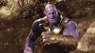 a purple thanos holding a infinity gauntlet in his hand