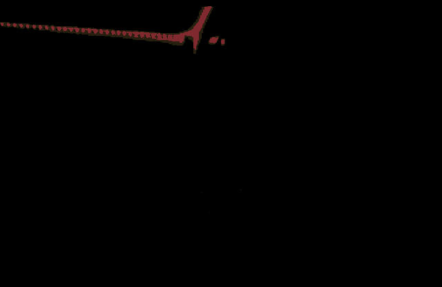 a close up of a person 's face in the dark with a red light behind him .