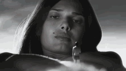 a black and white photo of a woman holding a smaller person