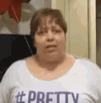 a woman is wearing a white shirt that says `` pretty '' .