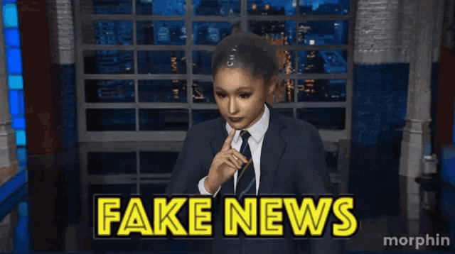 a woman in a suit and tie says fake news on a screen